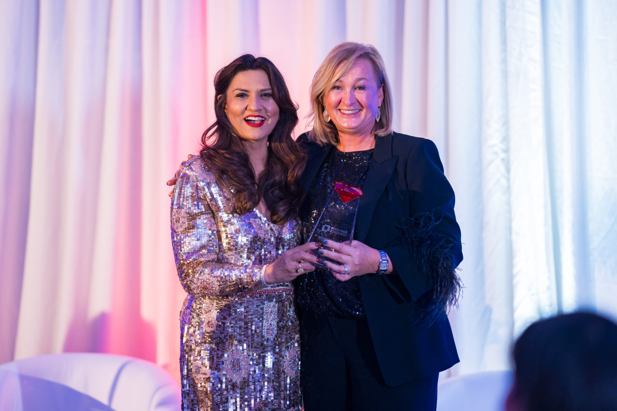 Two honorees with an award