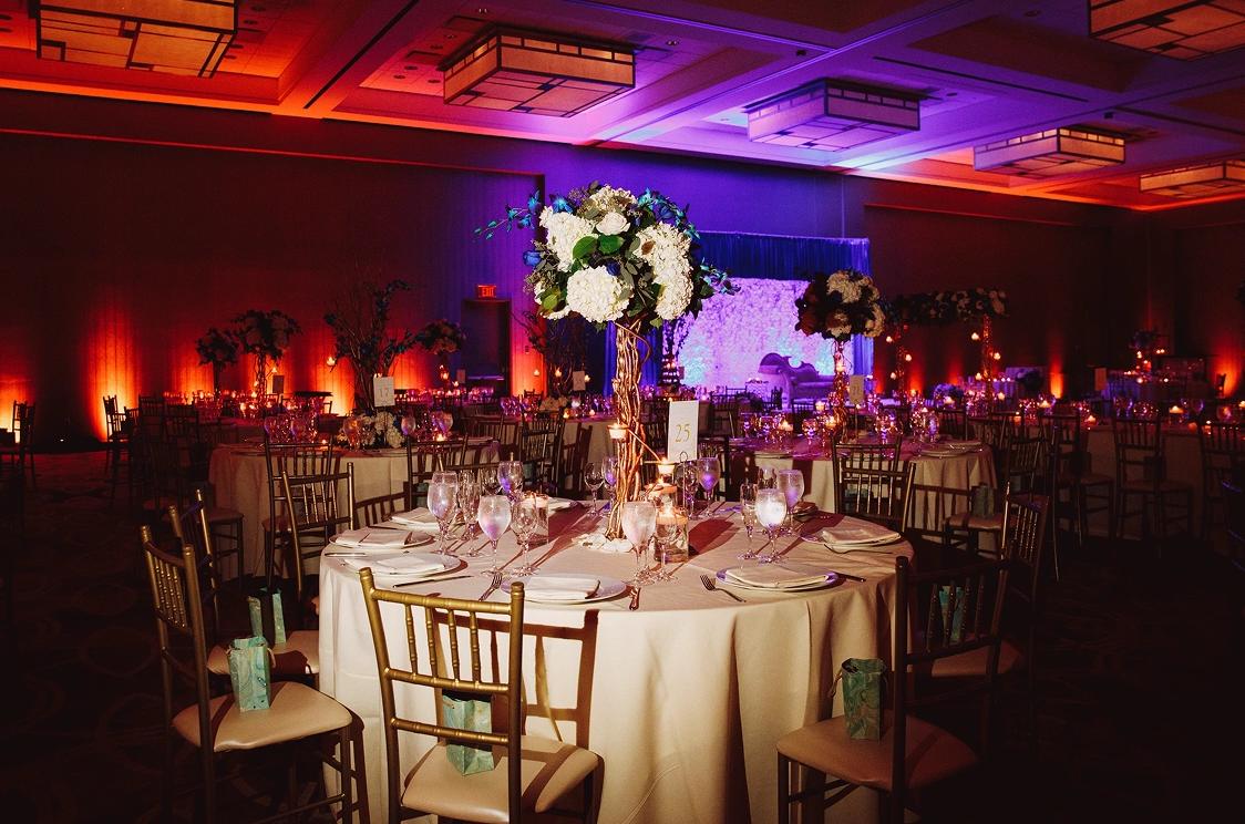 Gala dinner tables set beneath warm uplighting