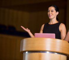 Female business executive giving a speech